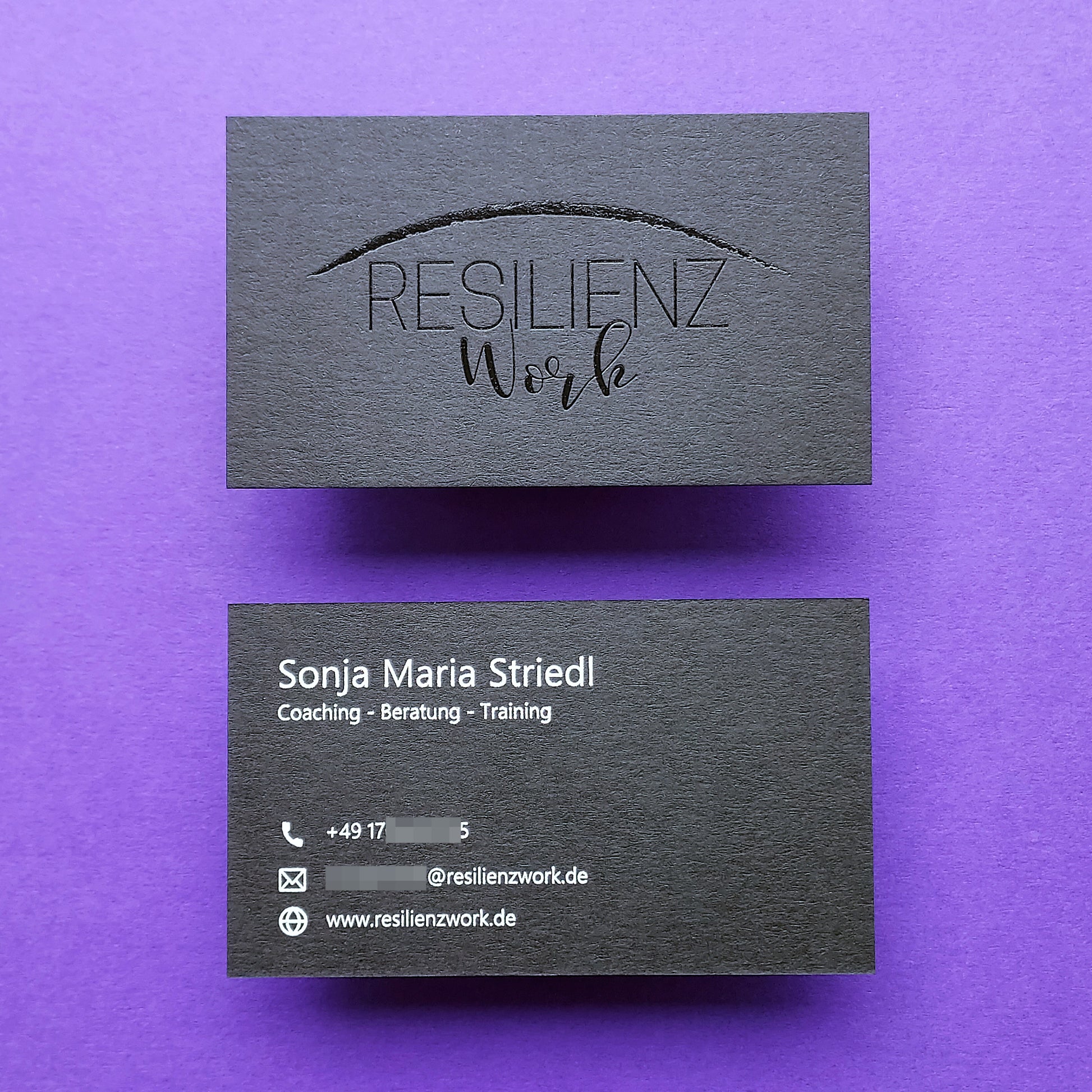 Debossed black card with premium letterpress texture