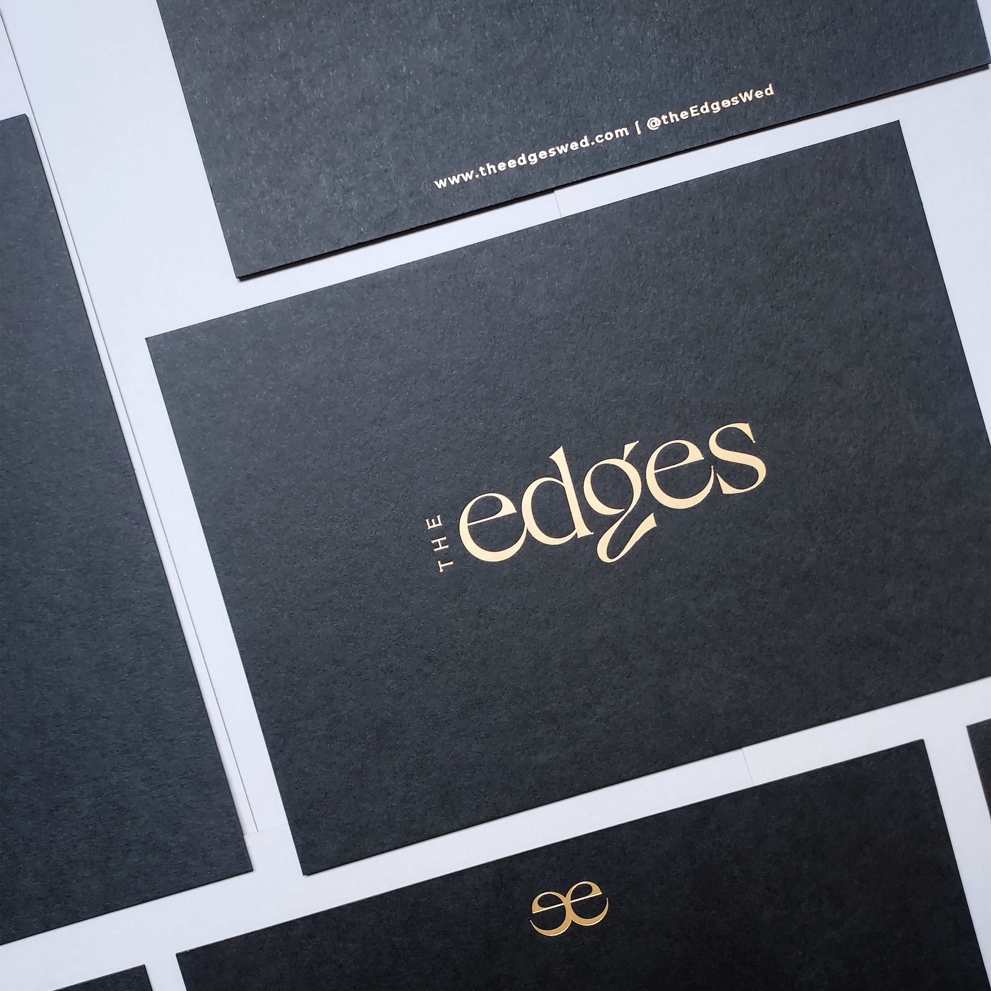 Artistic black postcard with custom foil accents and tactile deboss.