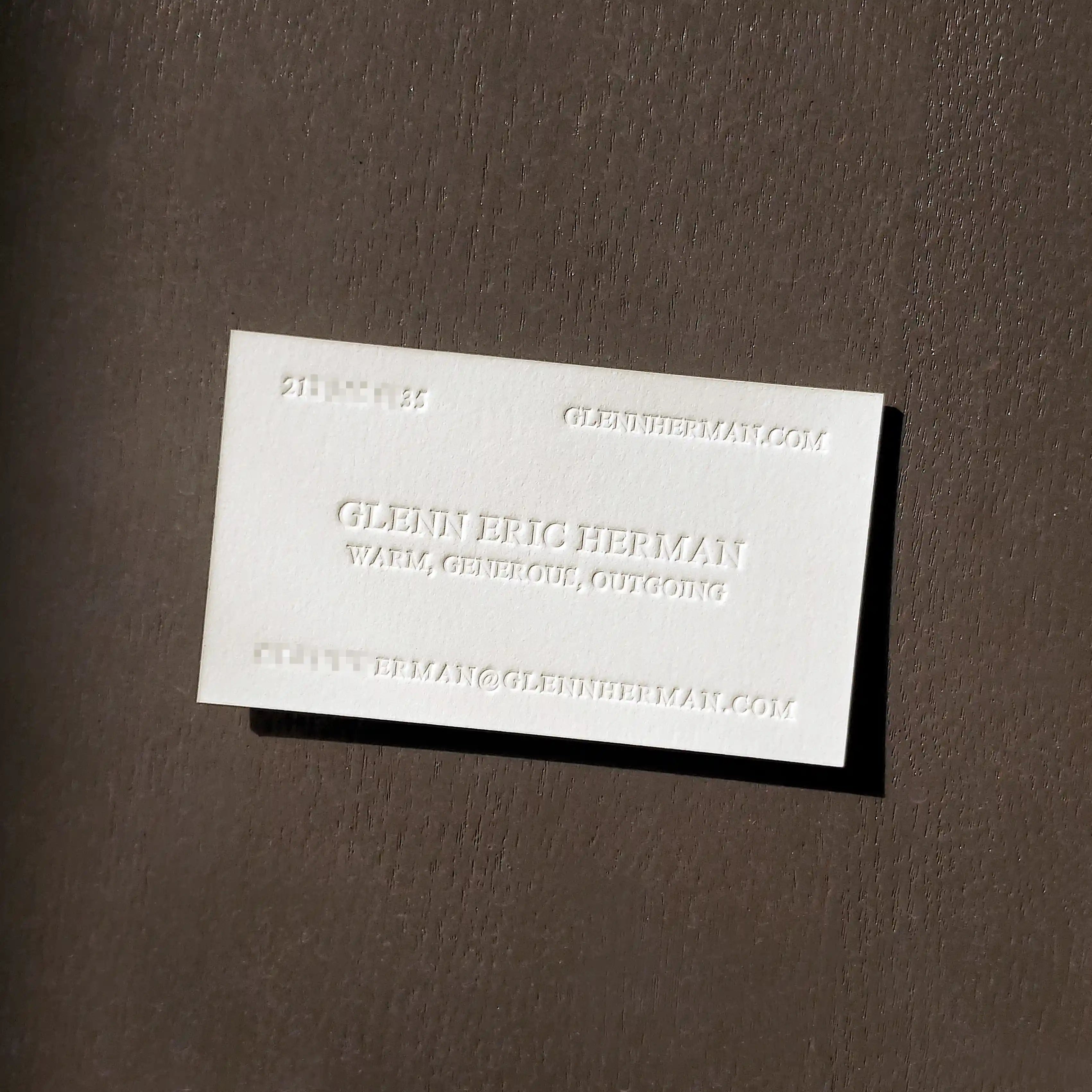 OddPlanPrint's 45pt cotton business card with a deep, inkless blind letterpress impression, emphasizing its tactile quality and minimalist design.