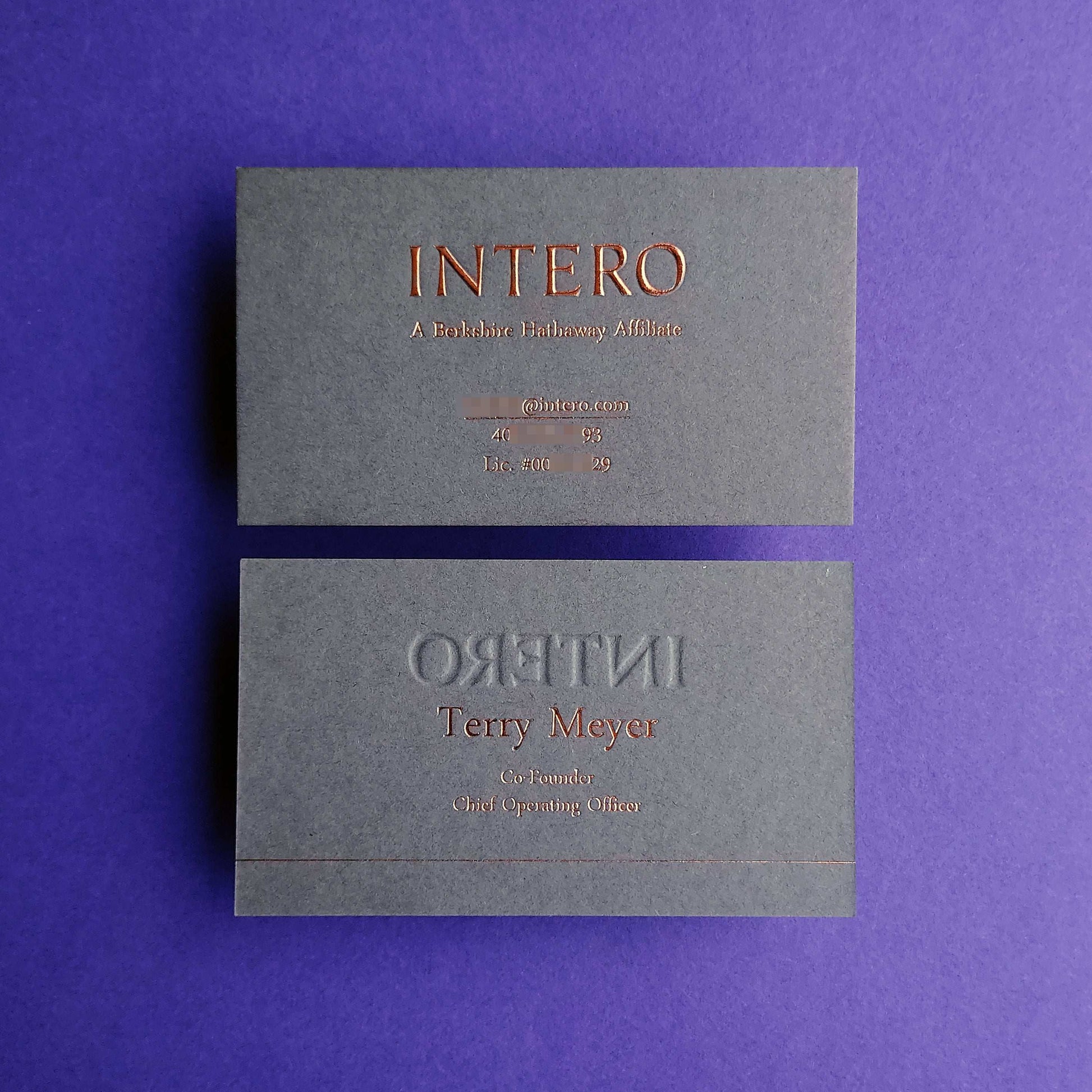 Handcrafted dark grey business card featuring deep emboss and fast shipping.