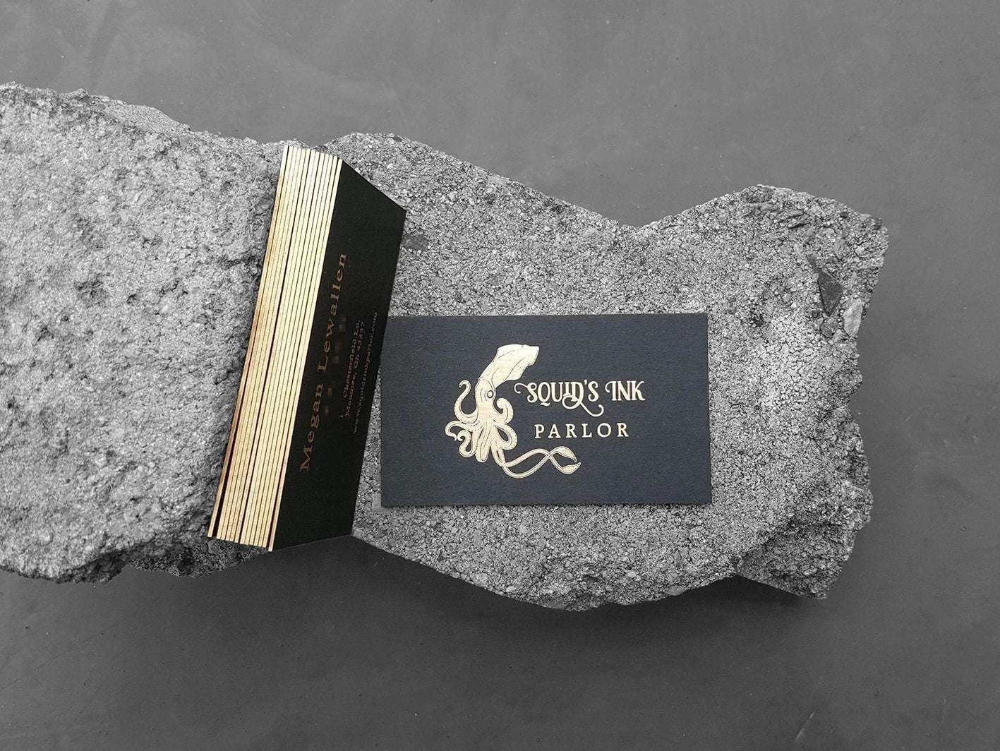 Exclusive black card with gold edge painting and fine foil accents.