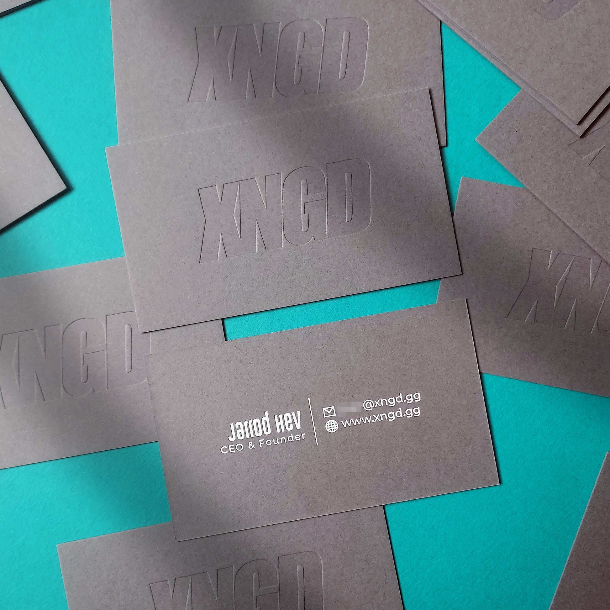 Foil-stamped dark grey card with letterpress texture for young professionals.