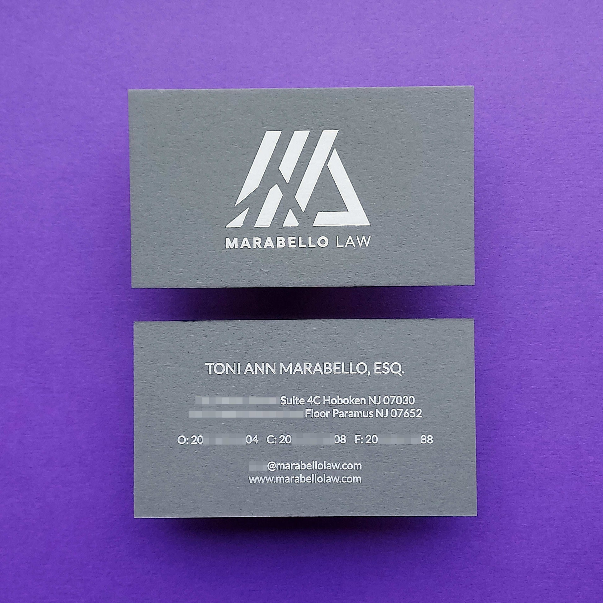 Tailor-made dark grey card with foil detail and artistic texture.