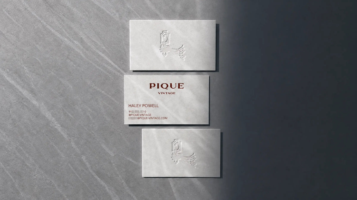 Premium 45pt cotton business card with debossed logo design and copper foil finish.