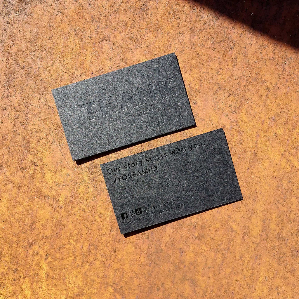Exclusive thick black card with precise blind deboss
