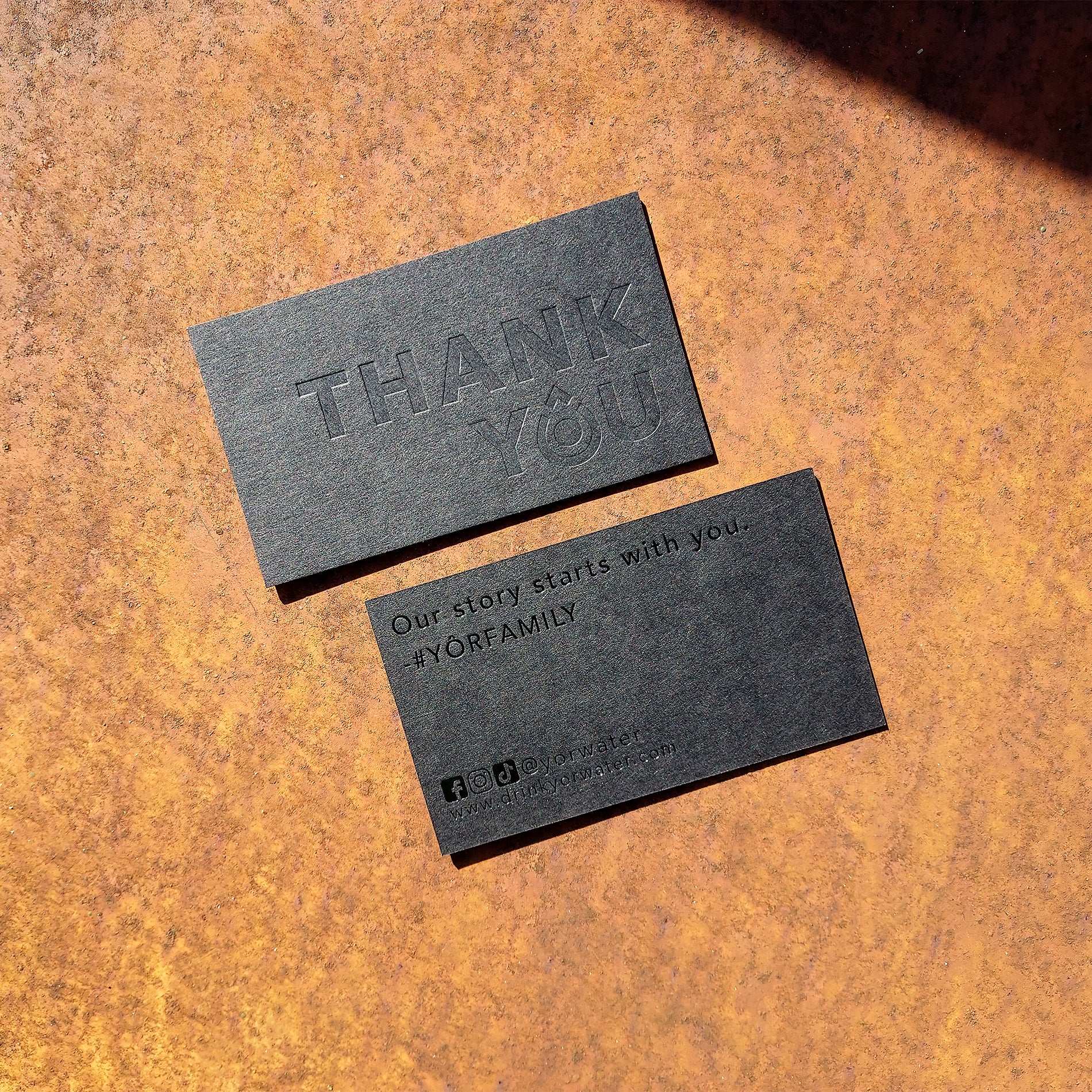 Exclusive thick black card with precise blind deboss