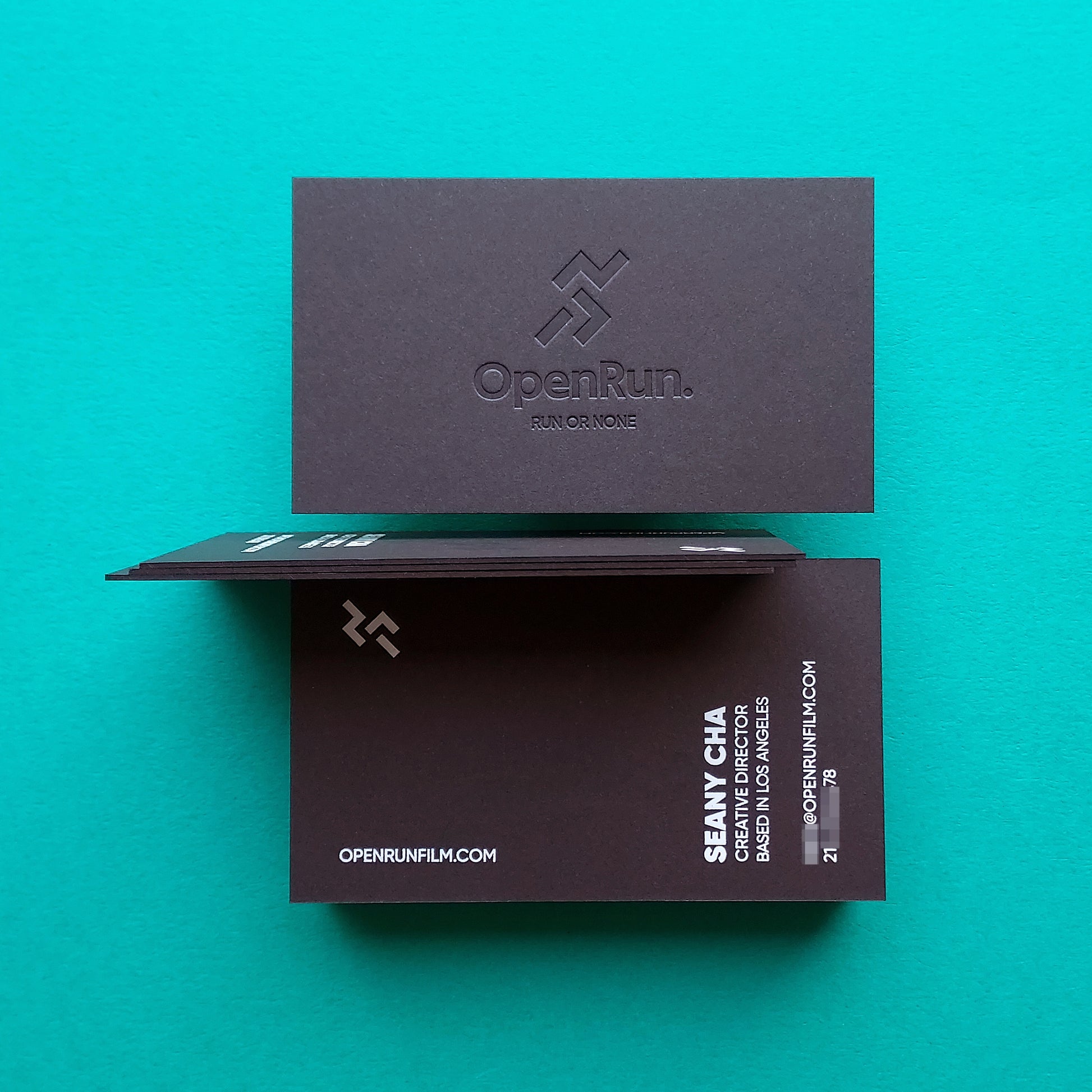 High-quality black card with custom blind deboss and foil