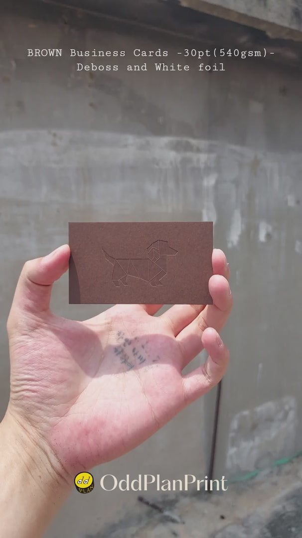 Luxury 30pt brown business cards featuring deboss and white foil by OddPlanPrint.