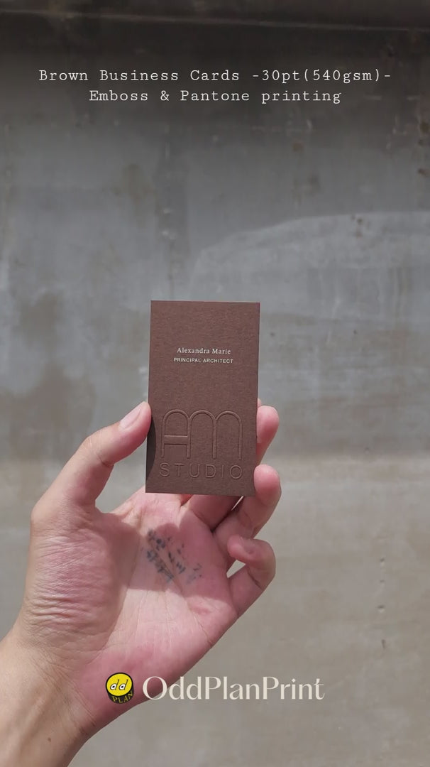 Premium brown business cards showing emboss texture and Pantone printing by OddPlanPrint.
