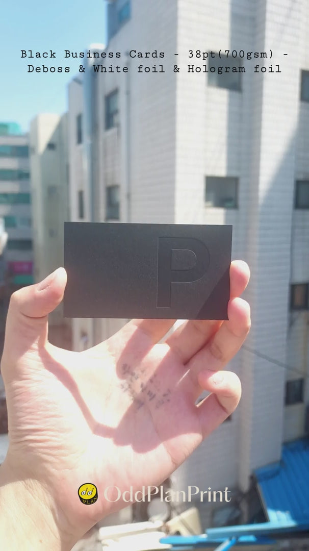 Luxury 38pt black business cards featuring blind deboss with white foil and hologram foil finishing by OddPlanPrint.