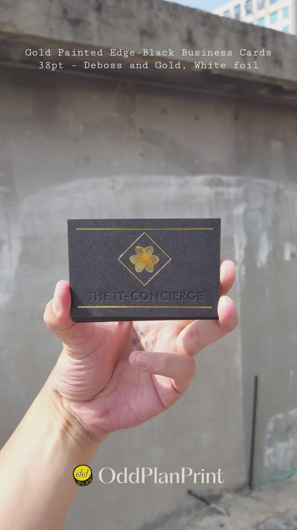 Gold-edged black business cards with deboss, gold and white foil by OddPlanPrint.