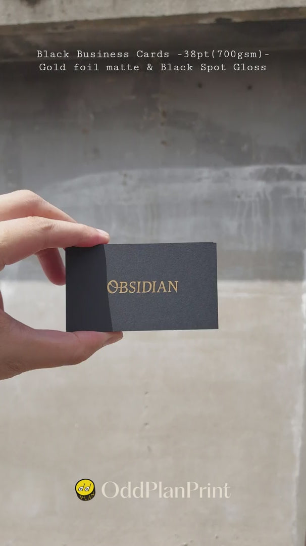 Thick 38pt black business cards with matte gold foil and spot uv gloss highlights produced by OddPlanPrint.