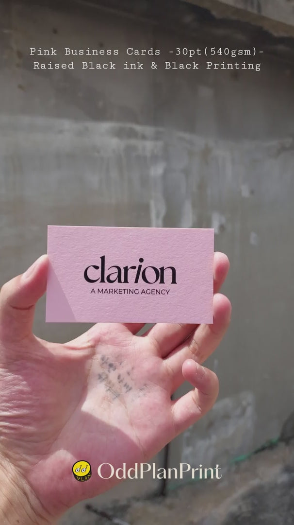 Premium pink business cards showing raised black ink texture on 30pt stock by OddPlanPrint.