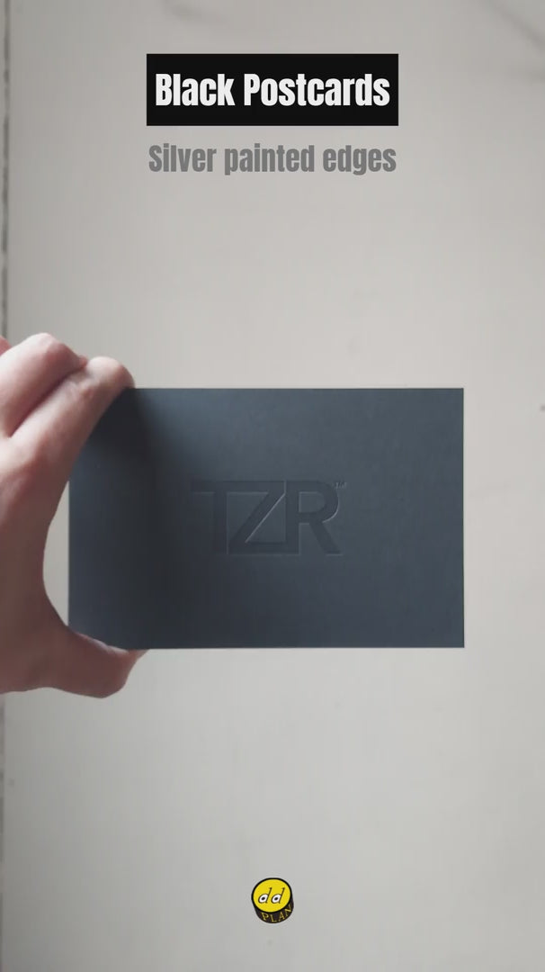 Black 38pt postcard with debossed logo, white foil text and silver painted edges - OddPlanPrint