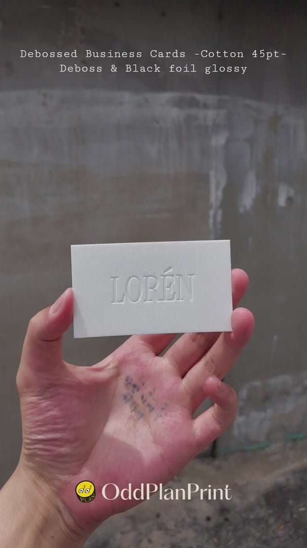 Premium debossed business cards on thick cotton stock with black foil accents by OddPlanPrint.