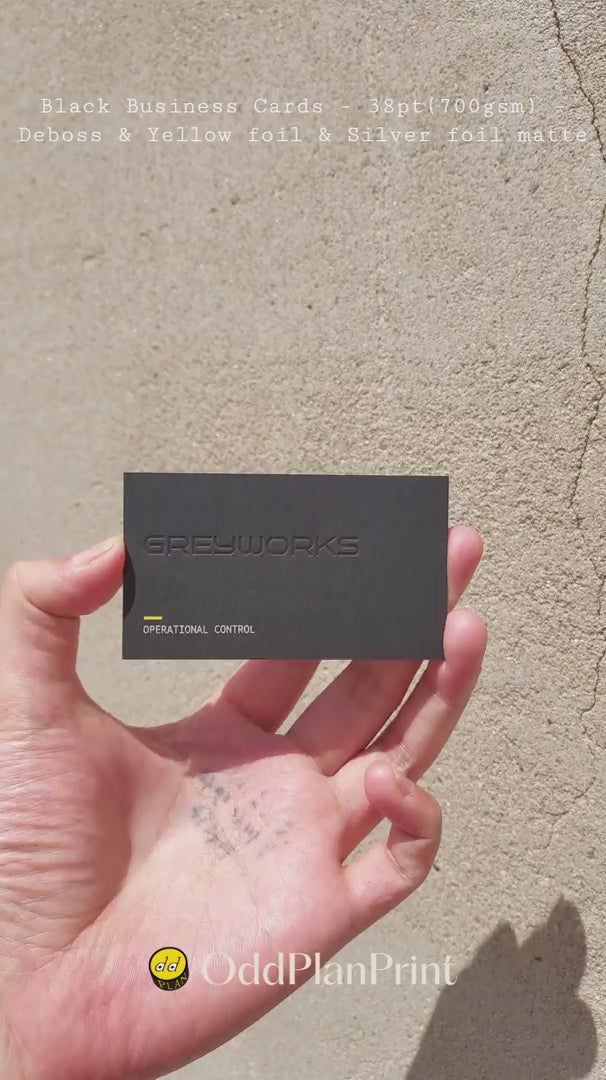 Luxury 38pt black debossed business cards combining yellow foil with matte silver foil by OddPlanPrint.