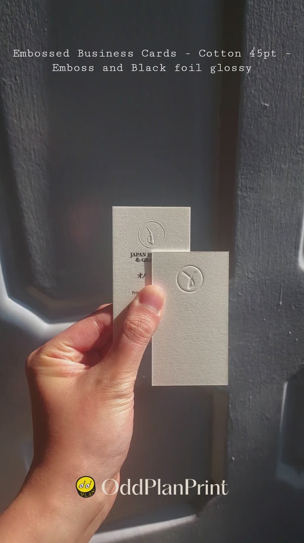 Luxury embossed business card printed on ultra thick 45pt cotton with glossy black foil logo, premium tactile finish crafted by OddPlanPrint.