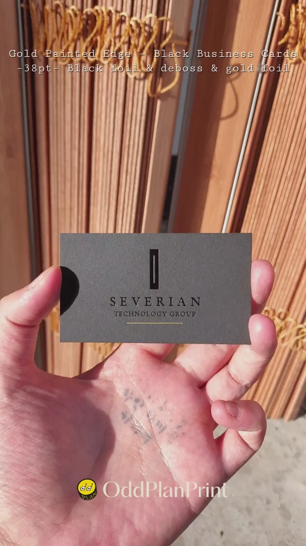 Gold foil and black foil and deboss on 38pt black business cards with gold painted edges custom crafted by OddPlanPrint.