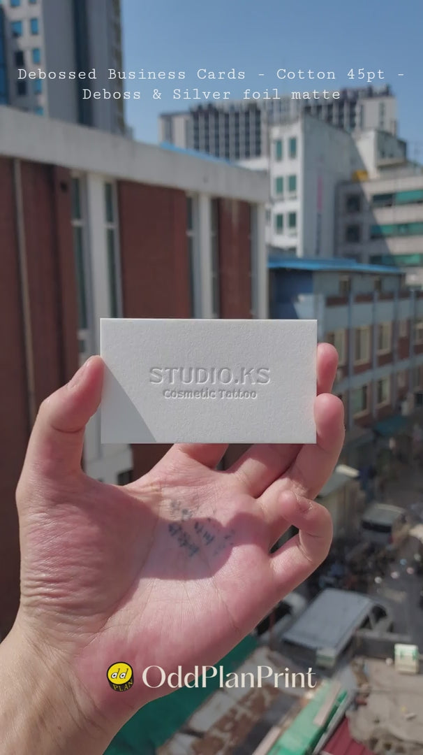 High quality debossed cotton business cards 45pt thick featuring blind deboss and silver foil finishing by OddPlanPrint.