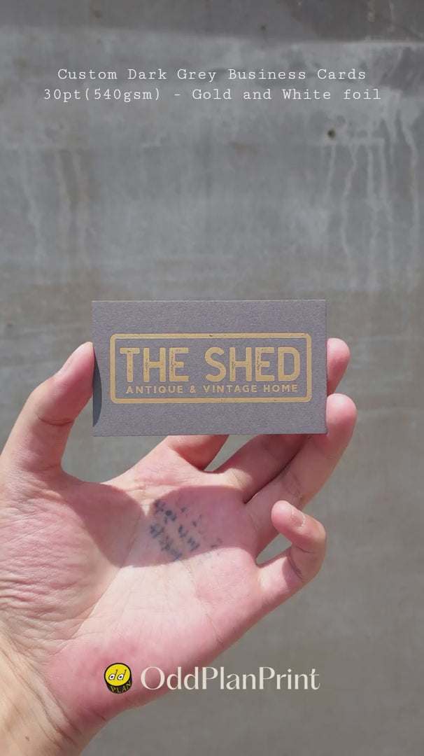 Custom dark grey business cards 30pt 540gsm with gold foil and white foil produced by OddPlanPrint.