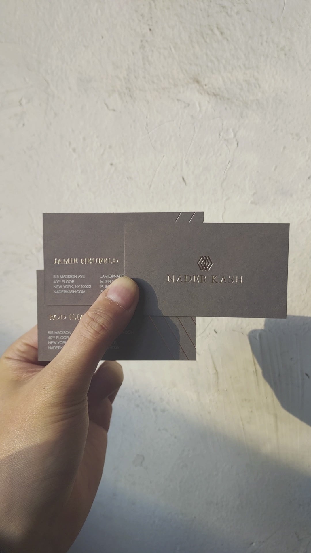 Sophisticated foil-stamped dark grey business card for professional teams.