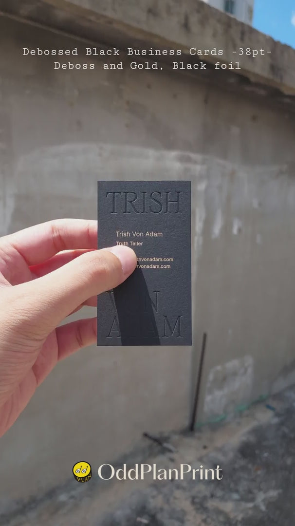 Modern black business cards 38pt thick showing deboss and gold, black foil accents from OddPlanPrint.