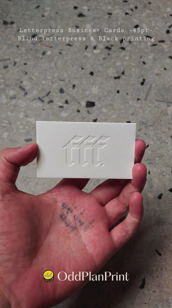 High-end 750gsm cotton business cards from OddPlanPrint showcasing deep blind letterpress indentations and stark black typography.