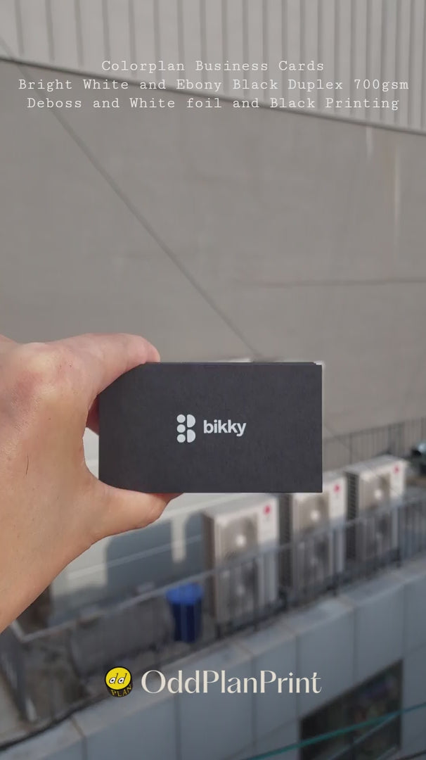 Premium 38pt duplex paper business cards with blind debossing and white foil stamping finished by OddPlanPrint.
