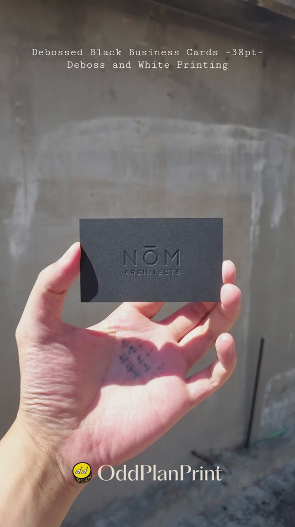 Minimalist black business cards combining debossed features with white ink, produced by OddPlanPrint.