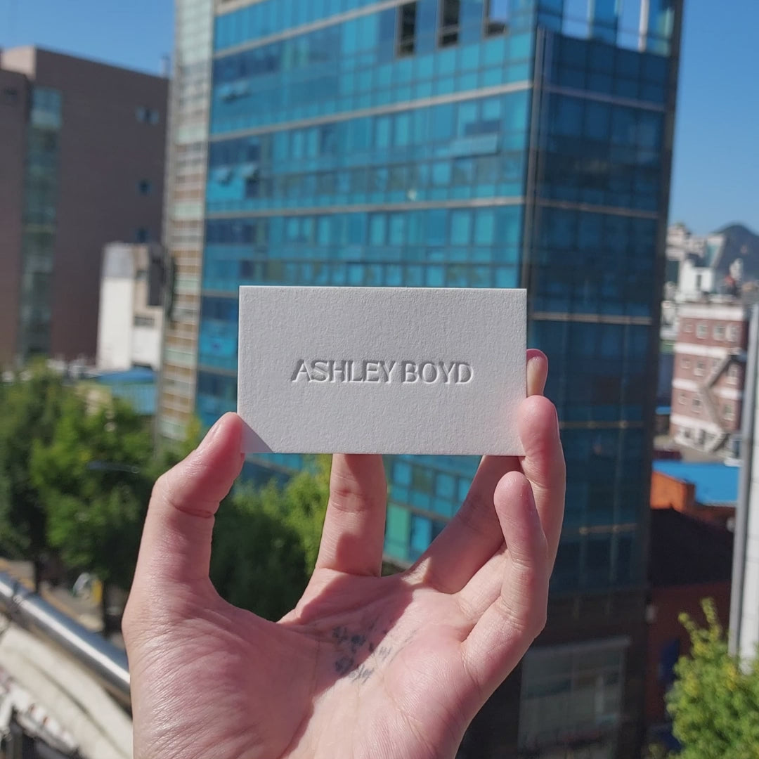 Custom-made business card with debossed logo for creative professionals