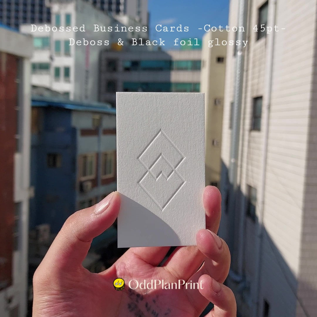 45pt cotton business cards with deep deboss and glossy black foil. Made at OddPlanPrint.