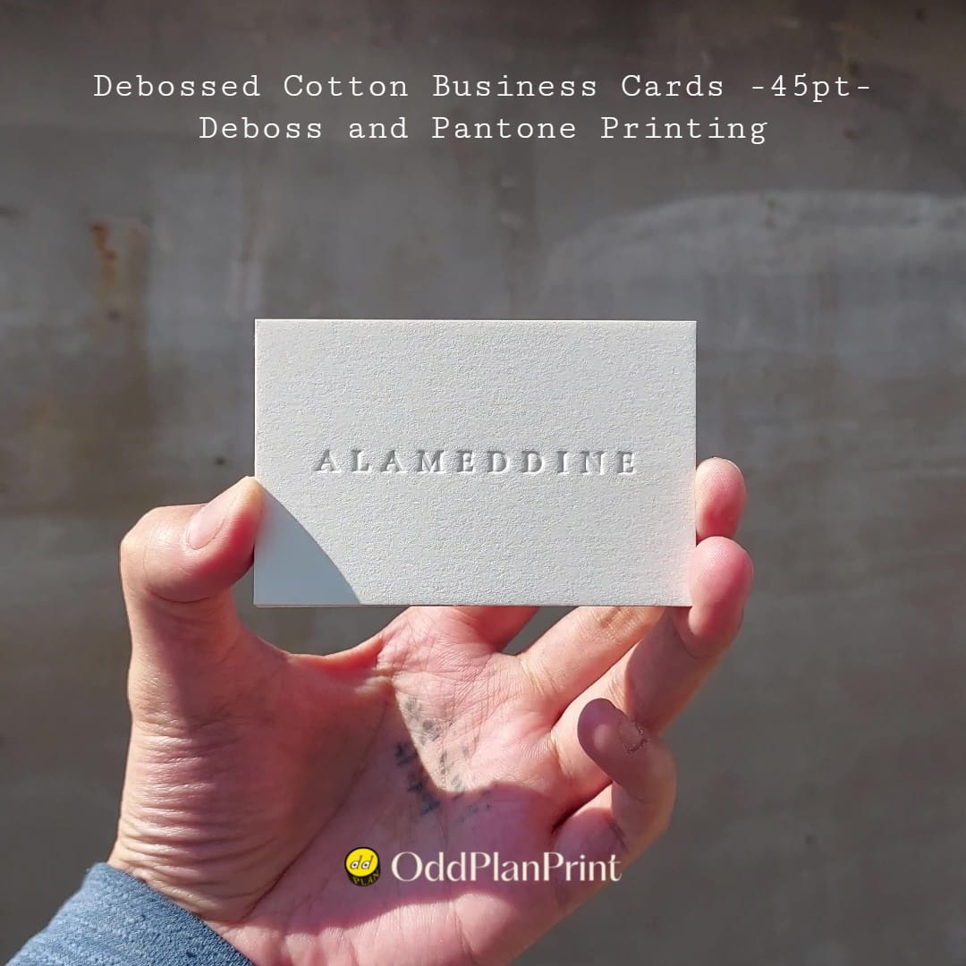 Brown Pantone business cards pair a blind deboss with tactile 45pt cotton by OddPlanPrint.