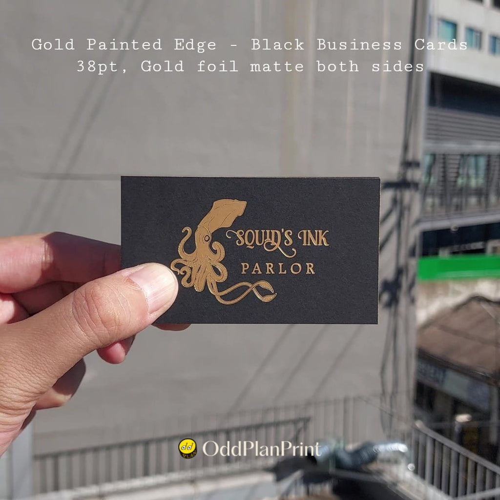 Gold edge business cards reveal matte foil on both sides in OddPlanPrint's premium black finish.