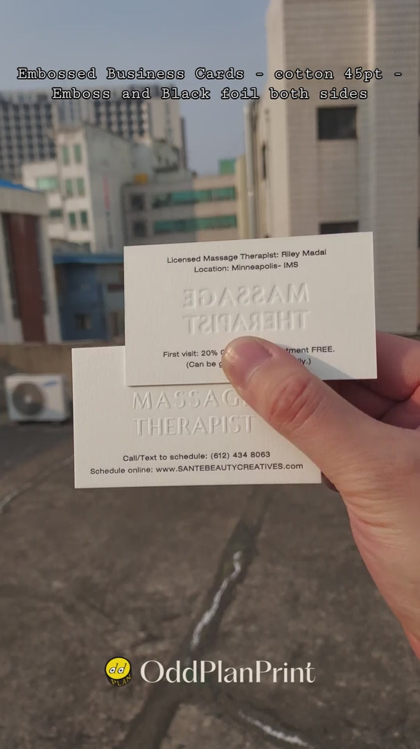 An elegant 45pt cotton business card by OddPlanPrint, featuring an embossed logo and a subtle black foil finish on both sides.