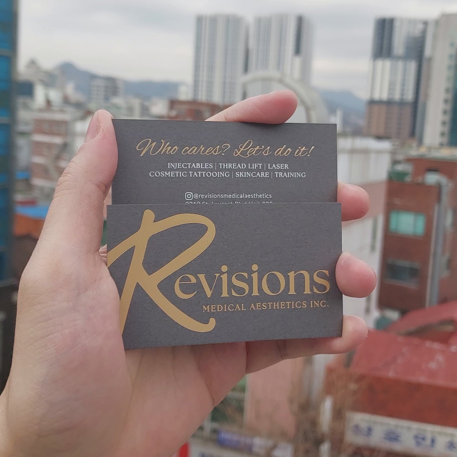 Dark grey business card with foil stamping and rich tactile quality.