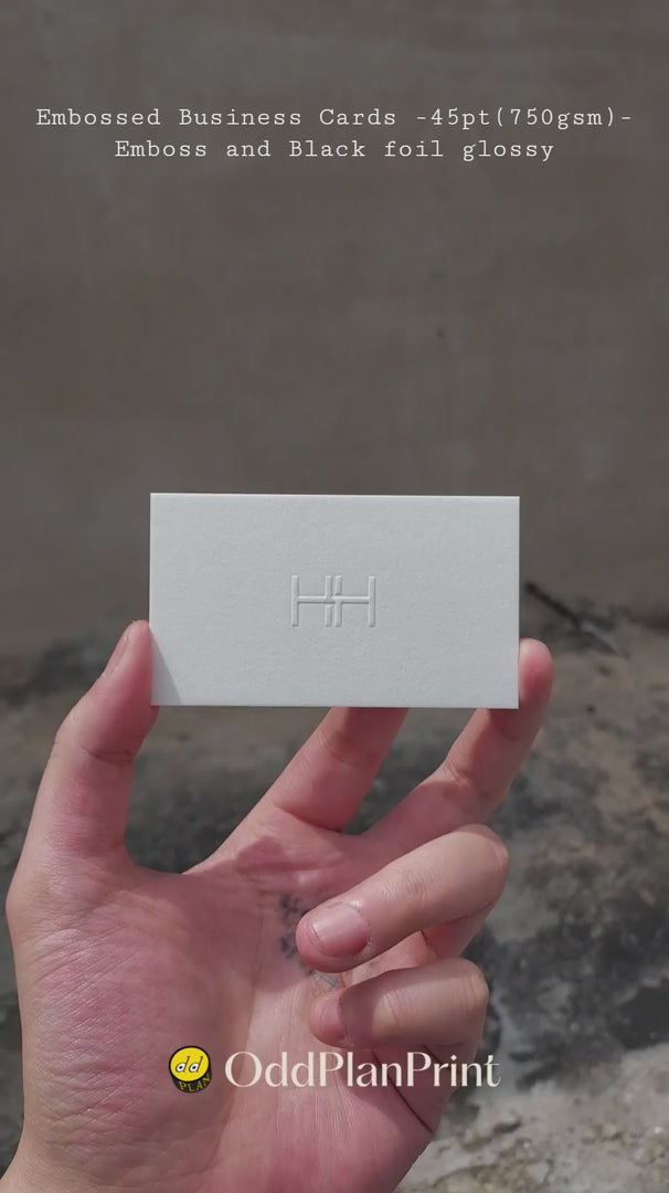 Premium embossed business cards on 45pt thick cotton with glossy black foil and raised emboss OddPlanPrint.