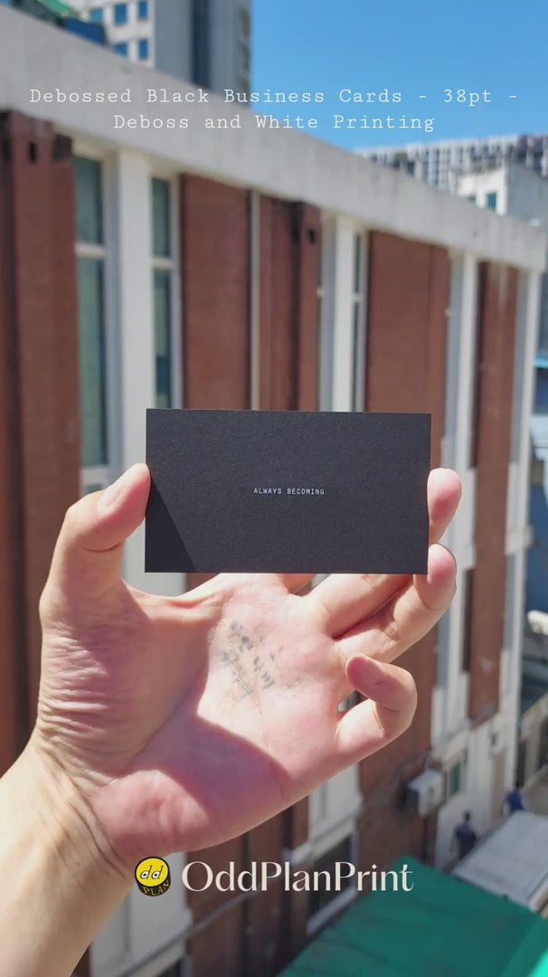 Black debossed business cards 38pt with blind deboss and white printing finished by OddPlanPrint.