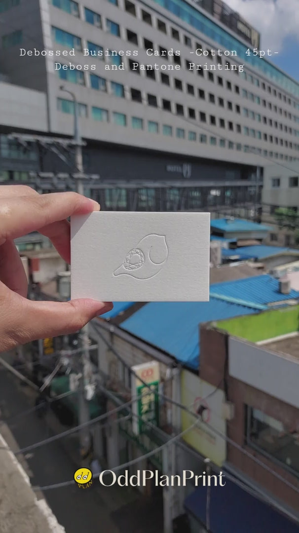 Premium 45pt cotton debossed business cards with Pantone printing produced by OddPlanPrint.