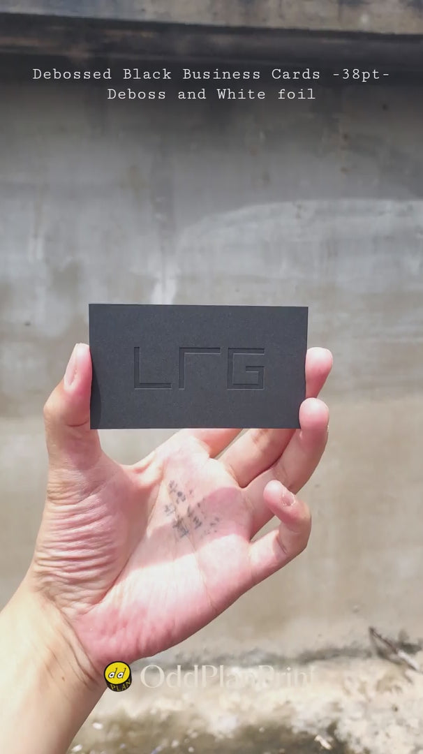 Luxury 38pt black debossed business cards with white foil finishing by OddPlanPrint.