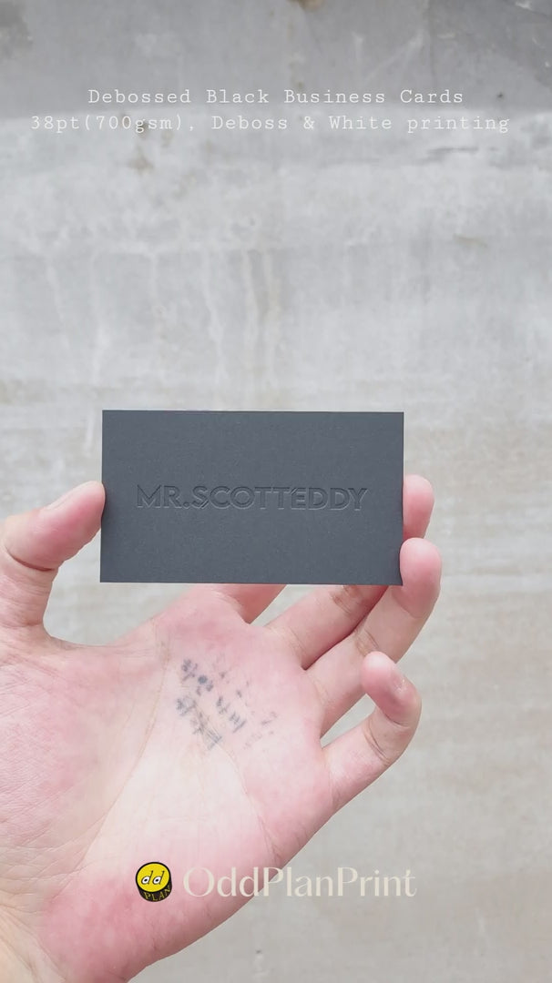 Modern debossed black business cards on 38pt 700gsm stock with deboss, white printing and vCard QR code from OddPlanPrint.