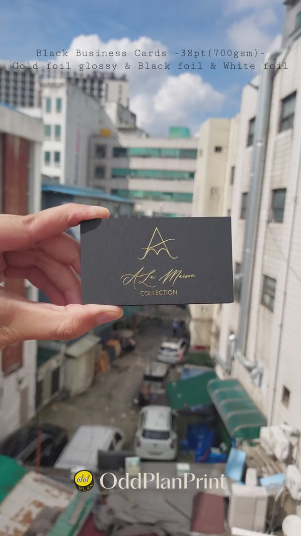 Premium 38pt thick black business cards with glossy gold, black and white foil produced by OddPlanPrint.