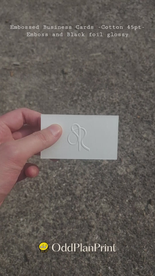 45pt Embossed cotton business cards with emboss and glossy black foil by OddPlanPrint.
