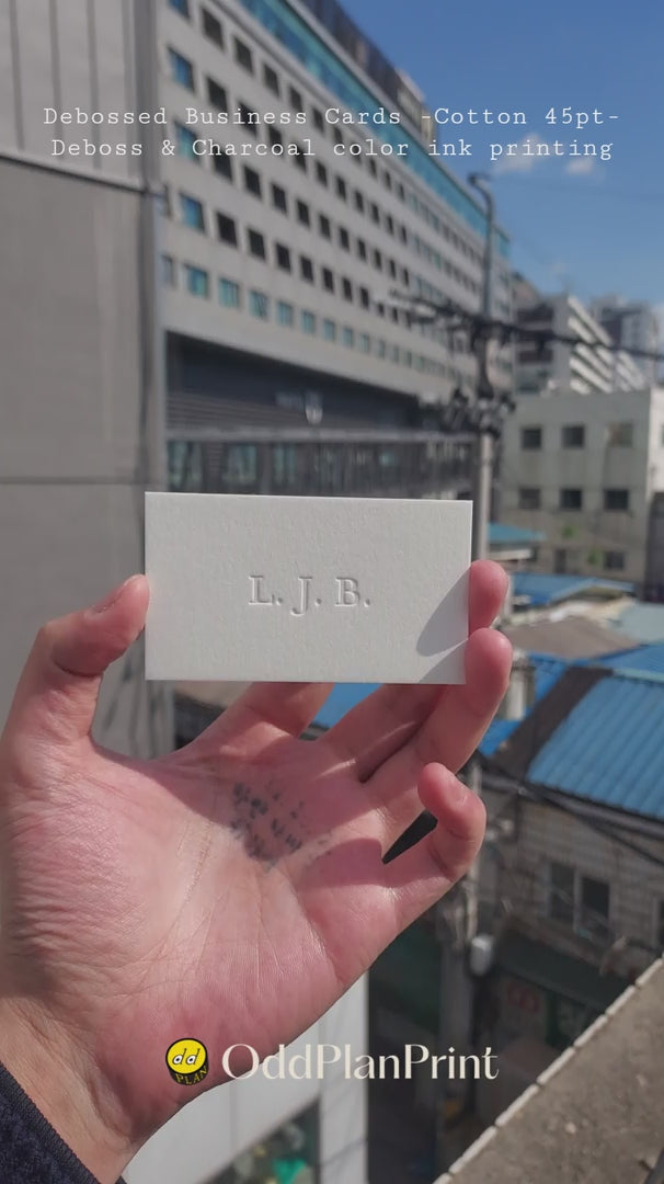 Premium debossed cotton business cards, blind deboss and charcoal ink printing by OddPlanPrint.