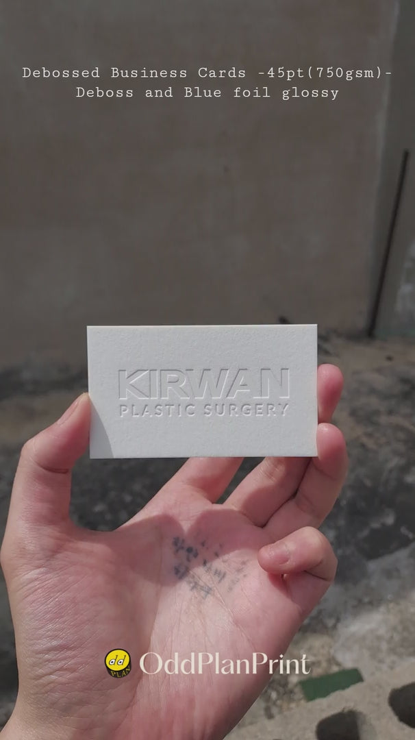 Luxury 45pt cotton debossed business cards featuring glossy blue foil by OddPlanPrint.