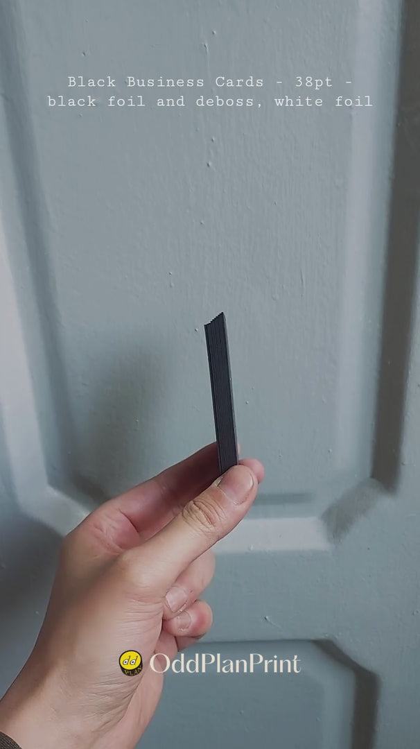 High-contrast 38pt black business card by OddPlanPrint, featuring black foil, white foil, and debossing for a sophisticated look.