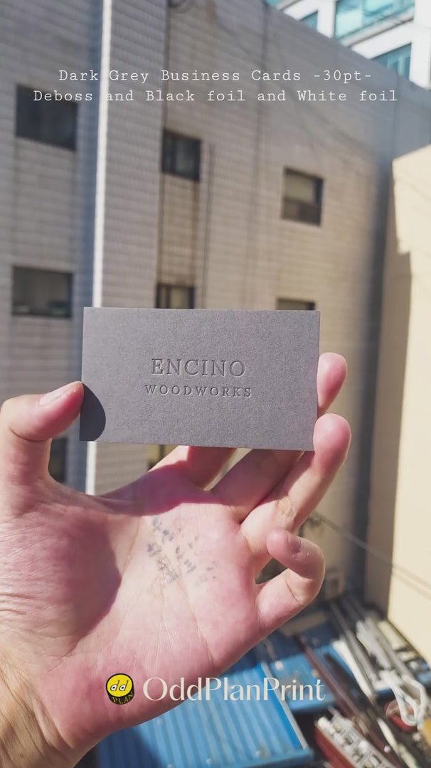 Elegant dark grey business cards 30pt 540gsm with deboss and dual black white foil finishing from OddPlanPrint.